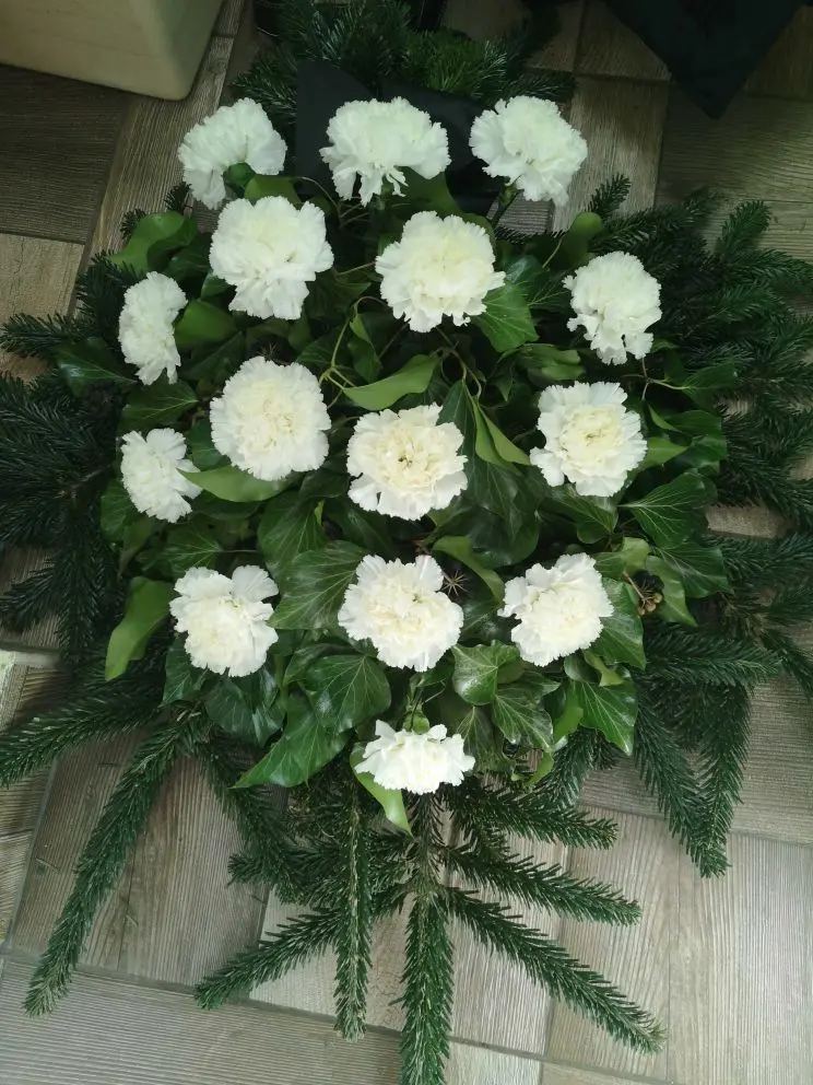 A sírcsokor kb.80cm, fenyő alapon díszített, fehér szegfű felhasználásával.